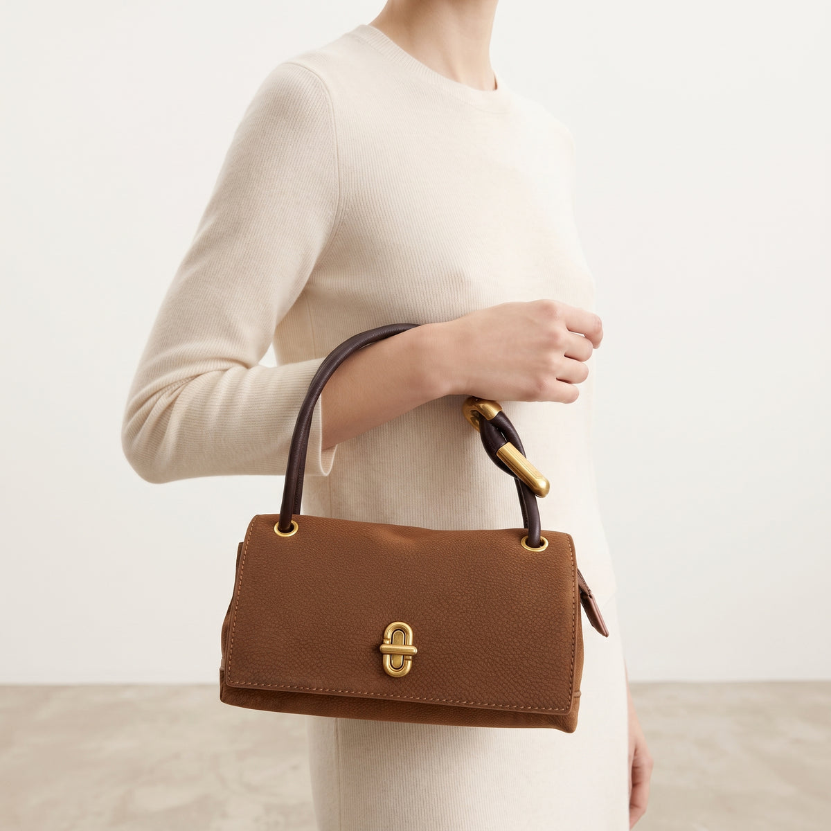 Modelo luciendo el bolso de hombro Elara de ante color camel.