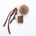 Llavero elegante con accesorio de mini bolso con estampado de leopardo, un pompón suave de color toupe, cordones trenzados a juego y herrajes metálicos dorados 